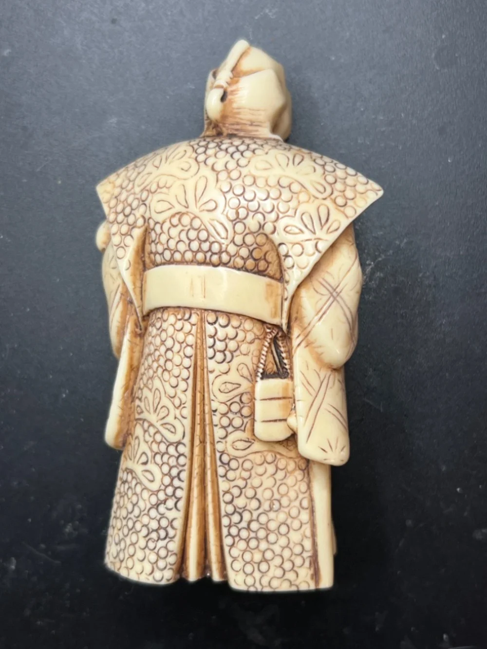 Hand-carved Japanese figurine likely a samurai or similar figure